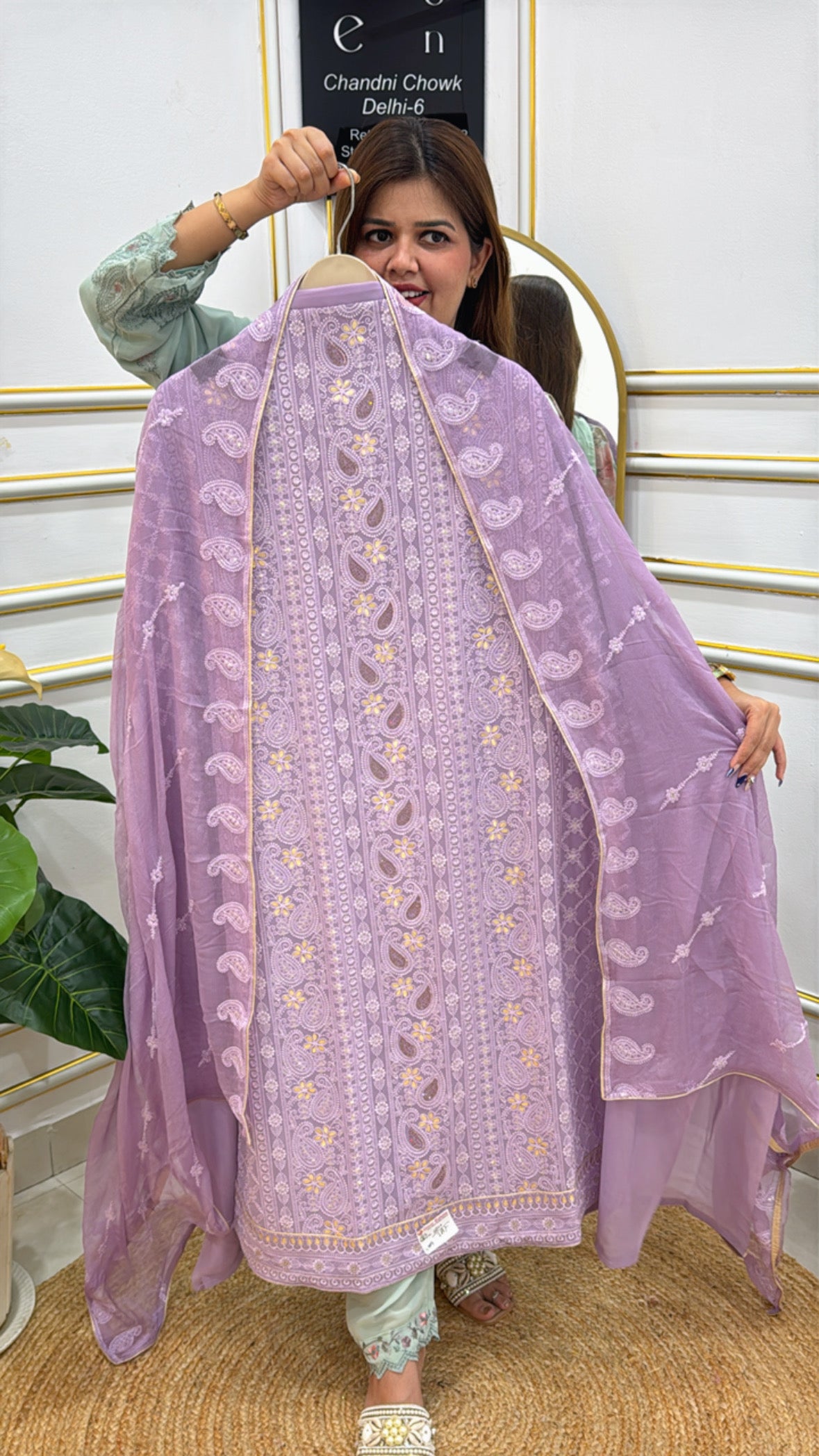 Model showcasing a beautiful unstitched Lucknowi suit in lavender with intricate embroidery details